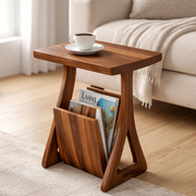 Wooden side table with magazine holder in a living room setting